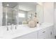 Elegant bathroom features a double sink vanity with modern fixtures and mirrors, plus a stylish glass walk-in shower at 218 Macon Lake Drive # 43, Apex, NC 27523