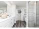 Modern bathroom featuring double sinks, stylish vanities, walk-in shower with grey textured tiling and a soaking tub at 218 Macon Lake Drive # 43, Apex, NC 27523