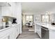 Bright, open kitchen with stainless steel appliances and a view of the dining and living areas at 218 Macon Lake Drive # 43, Apex, NC 27523
