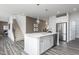 Modern kitchen features a large center island with pendant lights and stainless steel appliances at 218 Macon Lake Drive # 43, Apex, NC 27523