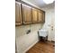 Laundry room with utility sink and upper storage cabinets at 2237 Keith Hills Rd, Lillington, NC 27546