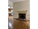Cozy living room with a brick fireplace and hardwood flooring at 2237 Keith Hills Rd, Lillington, NC 27546