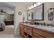 Bathroom showcasing granite countertop, double sinks, and natural wood cabinets at 2283 Mays Chapel Rd, Sanford, NC 27330