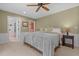 Cozy bedroom with neutral walls, soft carpet, and an adjoining bathroom and closet at 2283 Mays Chapel Rd, Sanford, NC 27330