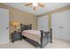 Neutral bedroom with black furnishings, ceiling fan, and carpet floors, exuding a calming atmosphere at 2283 Mays Chapel Rd, Sanford, NC 27330