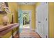 Welcoming entryway featuring wood floors, yellow walls, and view of the backyard at 2283 Mays Chapel Rd, Sanford, NC 27330