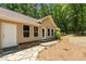 Exterior view of a home with a stone walkway, multiple windows, and a private entrance at 2283 Mays Chapel Rd, Sanford, NC 27330