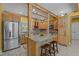 Spacious kitchen featuring custom cabinetry, granite island, stainless steel appliances, and rustic wooden beams at 2283 Mays Chapel Rd, Sanford, NC 27330