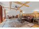 Comfortable living room with wood paneling, beamed ceiling, and rustic wood coffee table at 2283 Mays Chapel Rd, Sanford, NC 27330