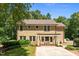 Stately home with large windows, a charming pergola, and a well-maintained yard in a serene setting at 2283 Mays Chapel Rd, Sanford, NC 27330
