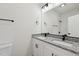 Modern bathroom featuring double sinks, granite countertops, and sleek black fixtures at 2301 Pinecroft Dr, Burlington, NC 27217