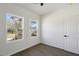 Bright, empty bedroom with two windows and wood-look flooring at 2301 Pinecroft Dr, Burlington, NC 27217