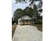 Inviting single-story home featuring a cozy front porch and a spacious new driveway at 2301 Pinecroft Dr, Burlington, NC 27217