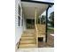 Detail of the welcoming front porch featuring wooden steps and railings at 2301 Pinecroft Dr, Burlington, NC 27217