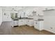 Well-lit kitchen featuring white cabinetry and stainless steel dishwasher at 2301 Pinecroft Dr, Burlington, NC 27217
