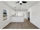 Bright living room featuring neutral walls and wood flooring leading to the open kitchen at 2301 Pinecroft Dr, Burlington, NC 27217