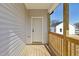 View of a porch featuring a white front door, wooden rails, and vinyl siding at 2301 Pinecroft Dr, Burlington, NC 27217
