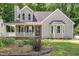 Beautiful home featuring neutral siding, a well manicured lawn and mature plantings at 2324 Dahlgreen Rd, Raleigh, NC 27615