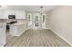 Bright and modern kitchen with white cabinets, quartz countertops, and stylish pendant lighting at 2324 Dahlgreen Rd, Raleigh, NC 27615