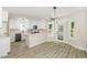 Modern kitchen featuring white cabinets, stainless steel appliances, and stylish lighting fixtures at 2324 Dahlgreen Rd, Raleigh, NC 27615