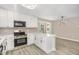 Modern kitchen features white cabinets, stainless steel appliances, and bright countertops at 2324 Dahlgreen Rd, Raleigh, NC 27615