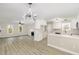Open-concept kitchen with stainless appliances, white cabinets, and seamless flow to the living area at 2324 Dahlgreen Rd, Raleigh, NC 27615
