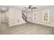 Bright, airy living room with new flooring, stairs, and windows, creating a welcoming atmosphere at 2324 Dahlgreen Rd, Raleigh, NC 27615