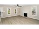 Bright living room featuring new flooring, a fireplace, and several windows for natural light at 2324 Dahlgreen Rd, Raleigh, NC 27615