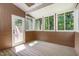 Cozy sunroom with wood-paneled walls and abundant natural light at 2324 Dahlgreen Rd, Raleigh, NC 27615