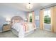 Bright bedroom with two windows, a light blue wall, and a bed with vibrant rainbow-themed bedding at 234 Macon Lake Drive # 39, Apex, NC 27523