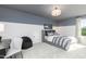 Comfortable bedroom design featuring a bed, accent wall, chair and a nearby window at 234 Macon Lake Drive # 39, Apex, NC 27523