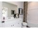 Bathroom featuring a vanity with framed mirror and tub shower with designer curtain and artistic accents at 242 Macon Lake Drive # 37, Apex, NC 27523