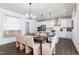 Bright kitchen and dining area featuring white cabinets, an island with seating, and modern pendant lighting at 242 Macon Lake Drive # 37, Apex, NC 27523