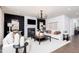 Beautifully staged living room featuring a fireplace, modern chandelier, and stylish decor at 242 Macon Lake Drive # 37, Apex, NC 27523