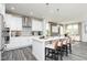 Bright kitchen features a large island with barstool seating, pendant lights, and modern stainless steel appliances at 254 Macon Lake Drive # 34, Apex, NC 27523
