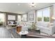 Bright open-concept living room with a large sectional sofa and seamless transition to the dining area at 254 Macon Lake Drive # 34, Apex, NC 27523
