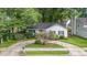 Aerial view of a cozy home surrounded by lush greenery and mature trees in a quiet neighborhood at 2629 Hiking Trl, Raleigh, NC 27615