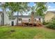 Backyard view featuring a wooden deck and a well-maintained lawn at 2629 Hiking Trl, Raleigh, NC 27615