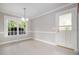 Bright dining area featuring tile floors, ample natural light from a large window, and access to an exterior door at 2629 Hiking Trl, Raleigh, NC 27615