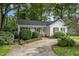 Charming single story home with a concrete driveway and a well maintained, manicured front yard and mature trees at 2629 Hiking Trl, Raleigh, NC 27615