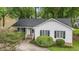 Charming home featuring a well-manicured front yard, classic white siding, and black shutters at 2629 Hiking Trl, Raleigh, NC 27615