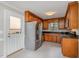 Kitchen features stainless steel appliances, granite countertops, and wooden cabinets, and a door to the exterior at 2629 Hiking Trl, Raleigh, NC 27615