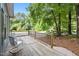 Inviting wooden deck with comfortable seating and a view of lush greenery at 2704 Shaftsbury St, Durham, NC 27704
