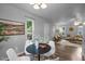 Bright dining area featuring hardwood floors, seating for four, and views into the living room at 2704 Shaftsbury St, Durham, NC 27704