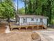 Charming light blue home with a spacious wooden deck and lush surrounding greenery at 2704 Shaftsbury St, Durham, NC 27704