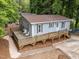 Cozy home showcasing a wooden deck with chairs, light blue siding, and a well-maintained landscape at 2704 Shaftsbury St, Durham, NC 27704