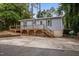 Charming single story home with a large driveway, wooden deck, and manicured landscaping at 2704 Shaftsbury St, Durham, NC 27704
