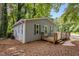 Well-kept home with a large wooden deck, black shutters, and a view of the surrounding landscape at 2704 Shaftsbury St, Durham, NC 27704