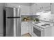 Bright kitchen featuring stainless steel appliances and white cabinetry at 2704 Shaftsbury St, Durham, NC 27704