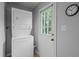 Laundry area with stacked washer and dryer, adjacent to an exterior door at 2704 Shaftsbury St, Durham, NC 27704